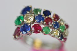 A stylish three row emerald, ruby, sapphire and diamond ring in 18ct white gold. Est. £600 - £650.