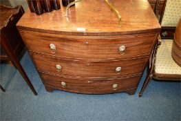 A mahogany bow front chest of three drawers with lion mask handles. Est. £100 - £120.
