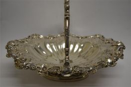 A good quality Victorian swing handle basket with embossed floral border and bright cut decoration