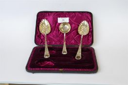 An attractive boxed pair of berry spoons with gilded bowls and matching sifter spoon. Sheffield