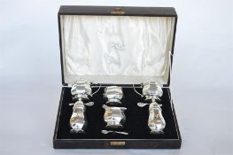 A large boxed 6 piece cruet set of octagonal form with blue glass liners. Birmingham 1937. By WG &