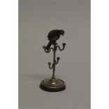 An unusual ring stand mounted with a macaw pin cushion on circular base. Birmingham 1921. Est £100 -