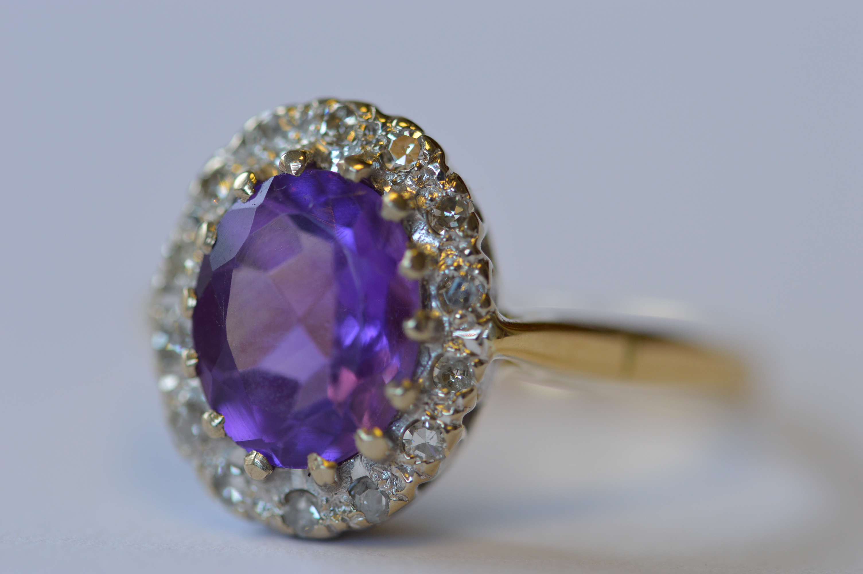 An attractive oval amethyst and diamond cluster ring. Est. £250 - £300.