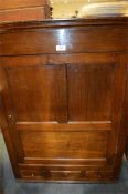 An Antique oak cupboard with three drawers and panelled door. Est. £40 - £60.
