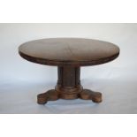 A Colonial mahogany Loo table with scroll carved drum base. Est. £280 - £300.