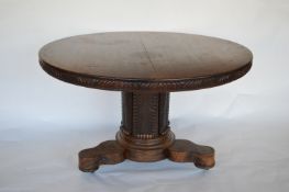A Colonial mahogany Loo table with scroll carved drum base. Est. £280 - £300.