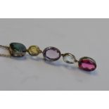 An attractive silver set pendant mounted with bright green tourmaline, citrine, amethyst, crystal