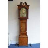 A long case clock with 30cms arched dial having Roman numerals in an oak and mahogany case. Signed