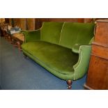 An attractive green velvet decorated settee with mahogany cabochon legs. Est. £100 - £150.