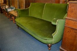 An attractive green velvet decorated settee with mahogany cabochon legs. Est. £100 - £150.