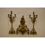 An attractive marble French clock garniture decorated with flowers and scrolls and lady reading