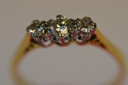 A small diamond three stone ring in 18ct. Est £90 - £120.