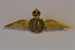 A 9ct enamel decorated RAF brooch with crown top. Approx 6.8 grams. Est. £50 - £60.