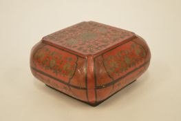 A Japanese red and black lacquer caddy with lift off cover. Est. £30 - £40.