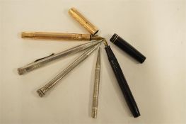 Five various silver and other pens. Est. £20 - £30.