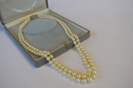 A good long double string of pearl beads with rose diamond three row clasp. Est. £750 - £800.