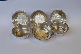 A set of six Eastern circular dishes with engraved decoration and reeded sides. Approx 515 grams.
