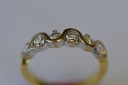 A heavy 18ct six stone band ring with wavy edge. Est. £350 - £400.