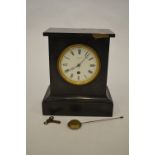 A heavy slate mantel clock with white enamelled dial. By Wadham of Bath. Est. £30 - £40.