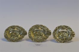 An unusual set of three ashtrays heavily embossed with figures and scrolls. Approx 55 grams. Est. £