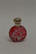 An attractive Webb's cameo red glass scent bottle of circular design, decorated with flowers and