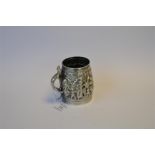 A good heavy Indian embossed mug profusely decorated with figures and flowers with lizard handle.