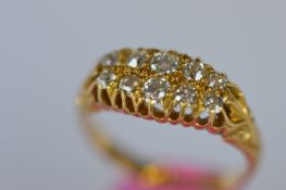 An 18ct double row cluster ring in claw mount. Est. £300 - £350.