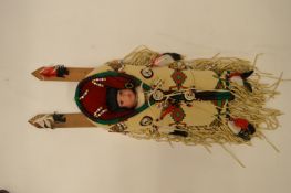 A modern Indian figure of a baby in papoose. Est. £10 - £15.