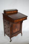A late Victorian rosewood tilt front Davenport with four drawers to side and fitted interior with