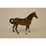 A Beswick figure of a stallion. Est. £20 - £30.