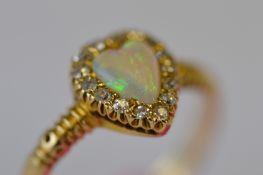 An attractive Victorian opal and diamond heart shaped cluster ring in claw mount with textured