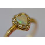 An attractive Victorian opal and diamond heart shaped cluster ring in claw mount with textured