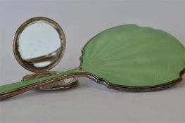 A green enamelled dressing table mirror together with a hinged top engine turned compact. Birmingham