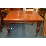 A mahogany 19th Century extending table with reeded supports and brass castors. Est. £100 - £120.