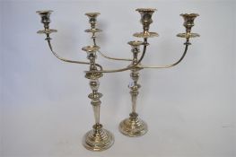 A large impressive pair of plated candleabra with gadroon rims. Est. £500 - £600.
