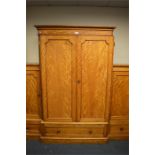 A satin birch triple wardrobe on pedestal base. Est. £250 - £300.