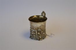 An attractive Victorian scroll decorated christening mug with embossed decoration on shell cap feet.