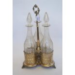 An impressive etched glass three bottle stand decorated with leaves and flowers. Est. £300 - £350.