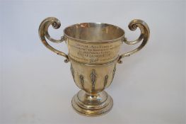 A good quality two handled trophy cup with reeded sides on pedestal base. Inscribed "Royal Air Force