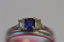 An attractive sapphire and diamond three stone baguette cut ring set in platinum together with a