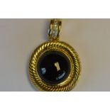 A heavy 18ct onyx mounted pendant with rope twist border and diamond loop top. Est. £300 - £350.