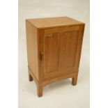 A good oak bedside chest on tapering supports. Est. £20 - £30.