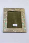 An attractive silver Arts and Crafts picture with green enamel decoration. Marked sterling. Est. £70