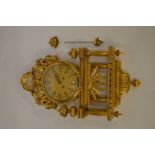 A large impressive gilt wall clock. 76cms high. Est. £100 - £120.