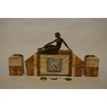 An Art Deco style marble clock garniture mounted with a lady in the recumbent position. Est. £