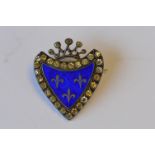 An attractive silver shield shaped brooch with paste border and enamelled centre. Est. £30 - £40.