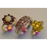 A heavy bundle of three 9ct gem set rings. Approx 8.8 grams. Est. £120 - £140.