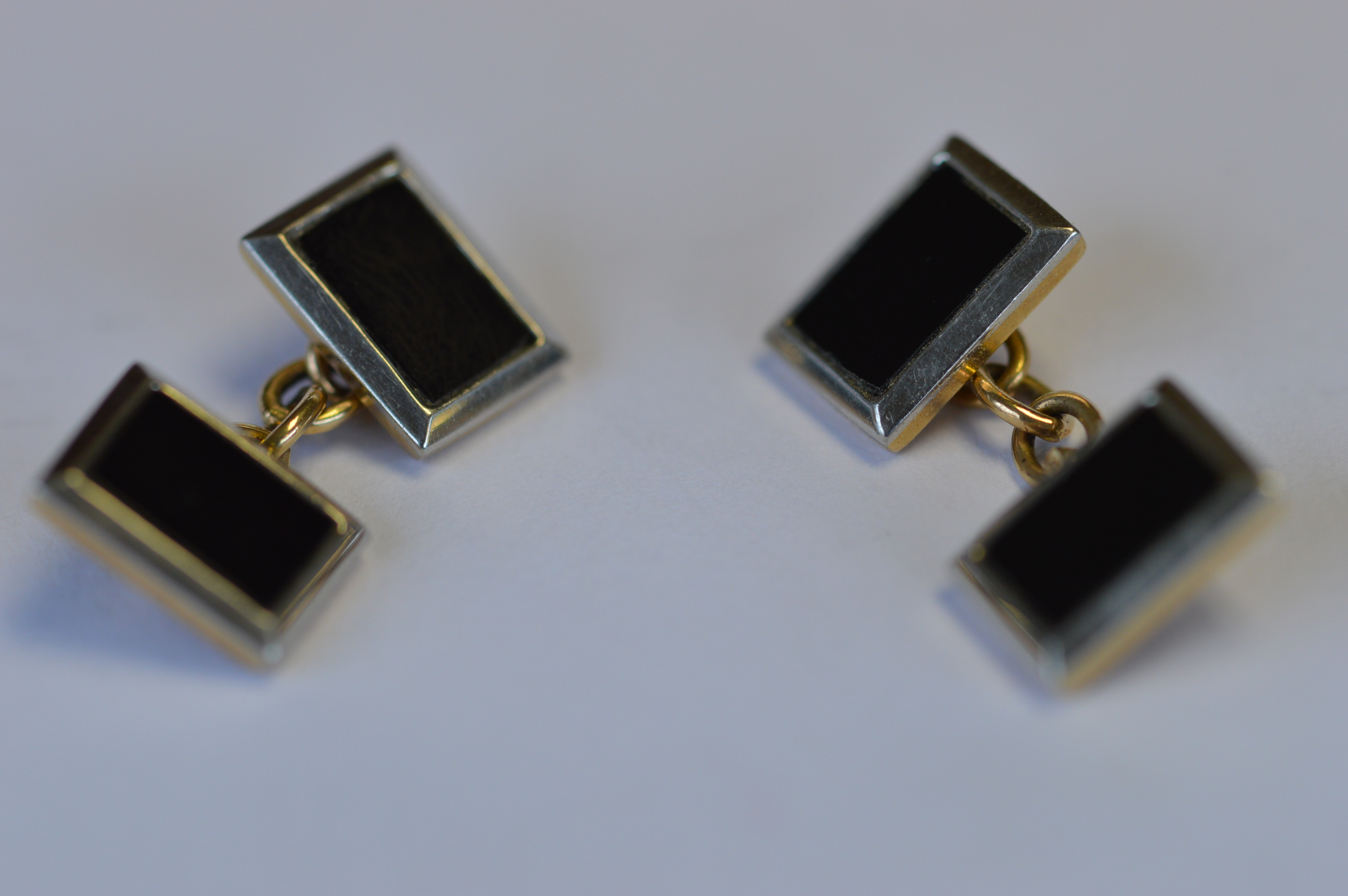 A heavy pair of platinum and gold cufflinks with onyx centres. Est. £150 - £200.