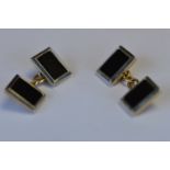 A heavy pair of platinum and gold cufflinks with onyx centres. Est. £150 - £200.