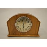 An Art Deco walnut mantle clock with chiming movement. Est. £25 - £30.